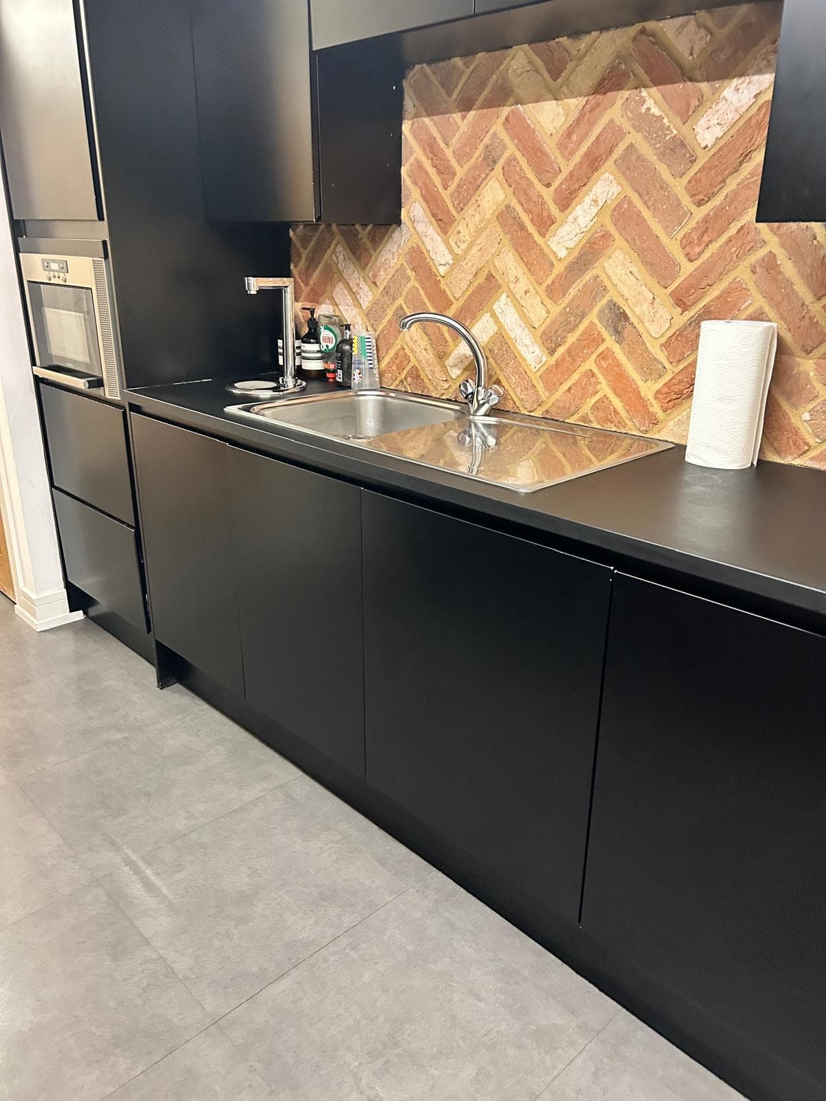 Modern dark kitchen with pendant lighting, cleaned and styled