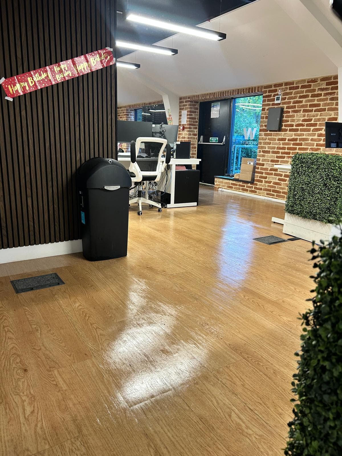 Office breakout area with exposed brick wall, cleaned floor