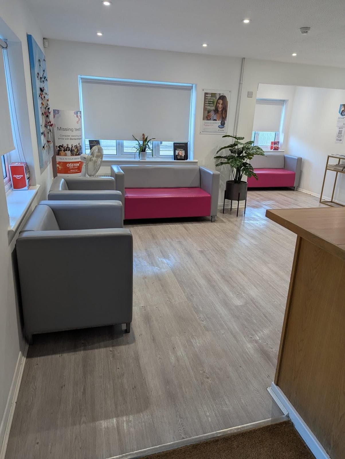 Reception and waiting area with pink seating, cleaned and tidy